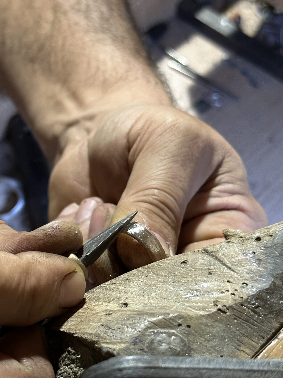 Cutting the detail of a ring by hand in the SPQR Shop workshop.